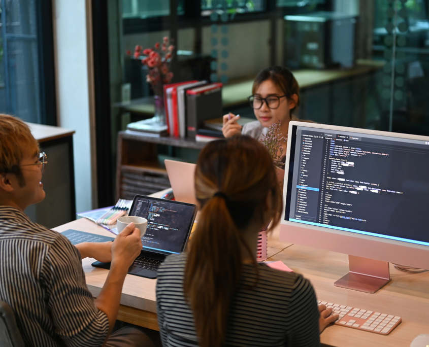 Back View Of Multiple People Working On Coding Shell