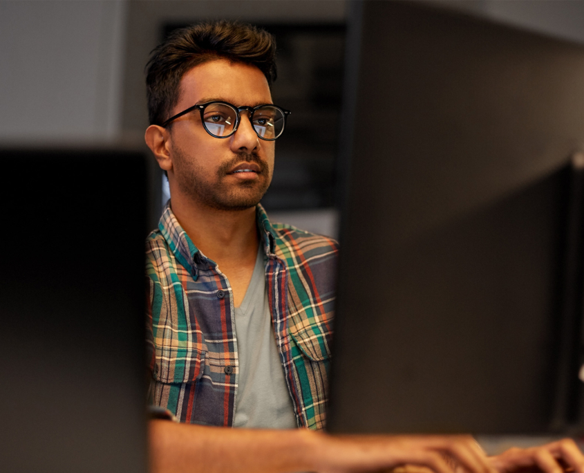 Close Up Of Creative Man In Glasses Working At Night Office And Thinking