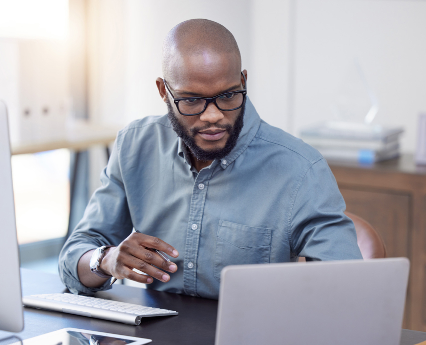 Front View Of Man Looking At Laptop Screen