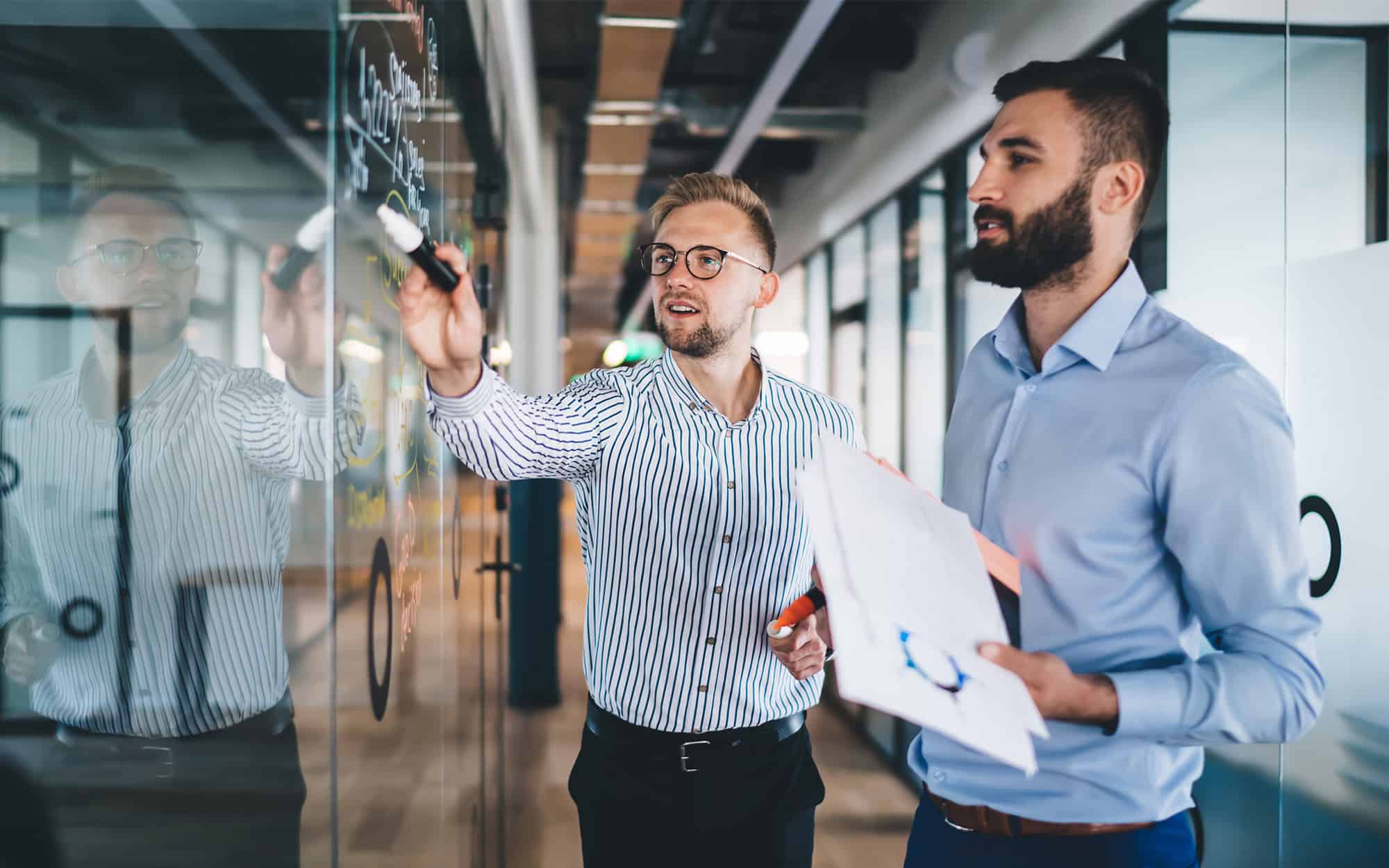 Smiling Male Employees Discussing Cooperation Planning, Side View