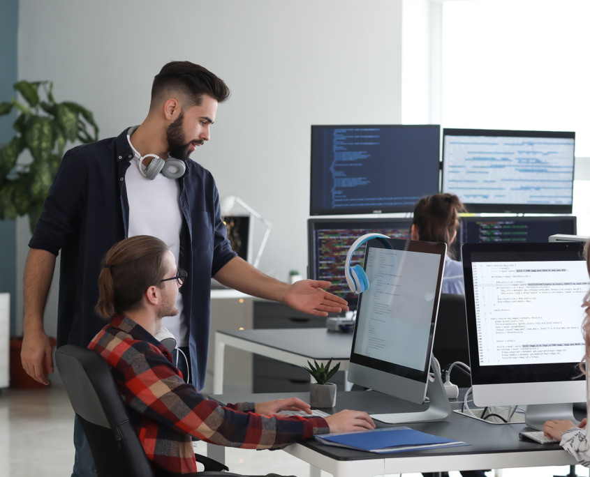 Team Of Programmers Working In Office, Side View